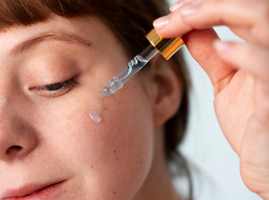 Woman applying serum to face