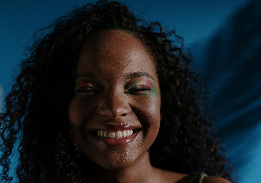 smiley teenager with blemished skin