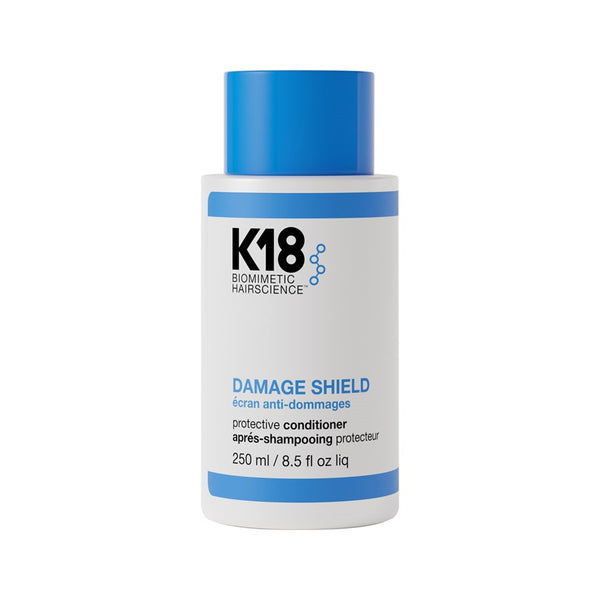 A bottle of K18 Damage Shield pH Protective Conditioner, with blue and white labeling, containing 250ml of liquid.