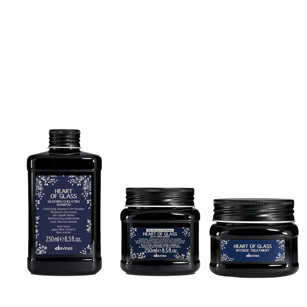 Three black hair care products with blue labels on a white background