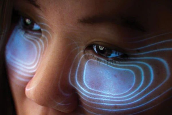 Close up of woman's face showing LED lights on her under eye area