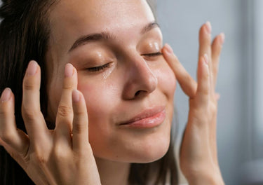 Lady massaging cream into her eyes and temples