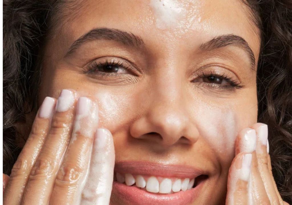 lady washing her face with glycolic acid face wash