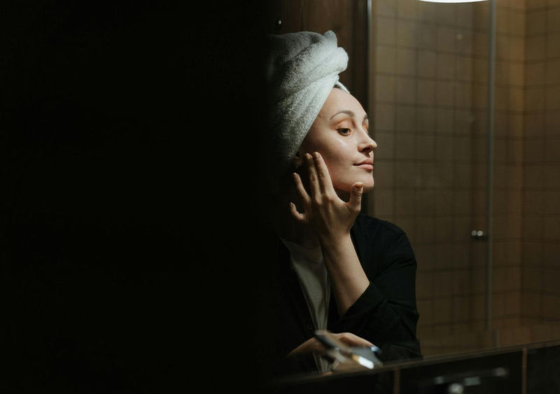 Lady applying face cream as part of her nighttime skincare routine