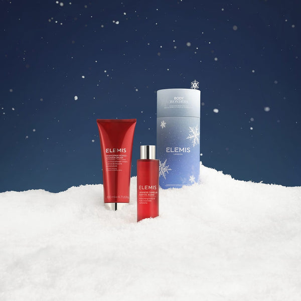 ELEMIS skincare products on a snowy background with a blue sky.