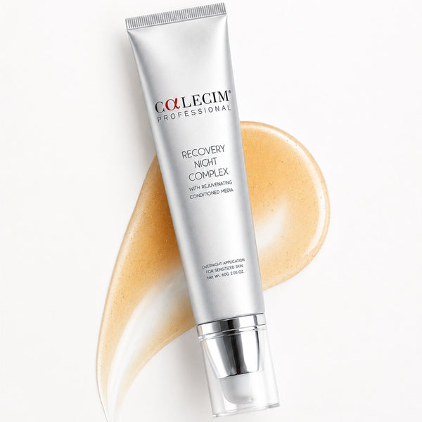 A silver tube of Collegim Professional Recovery Night Complex hair conditioner is displayed diagonally on a white background, overlaid with a curved smear of the beige-colored conditioner itself.