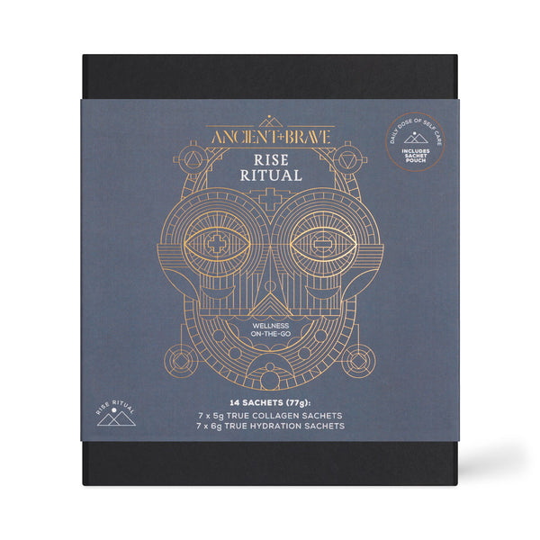 Ancient Brave Rise Ritual wellness sachets packaging, featuring a slate blue front cover with gold line art of a skull and geometric design, set against a black background.