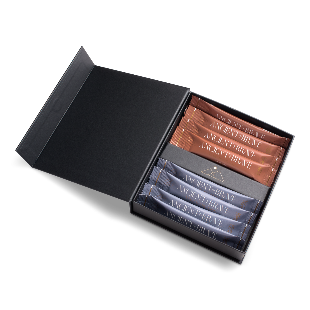 An open black gift box containing several small rectangular packets or sachets labeled ANCIENT BRAVE, arranged in two rows on a clean white background.