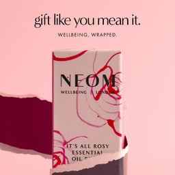 NEOM essential oil packaging on a pink background with text 'gift like you mean it.'