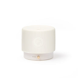 White cylindrical device with a textured surface on a white background