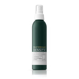 Green spray bottle with white cap labeled 'Philip Kingsley Density' on a white background