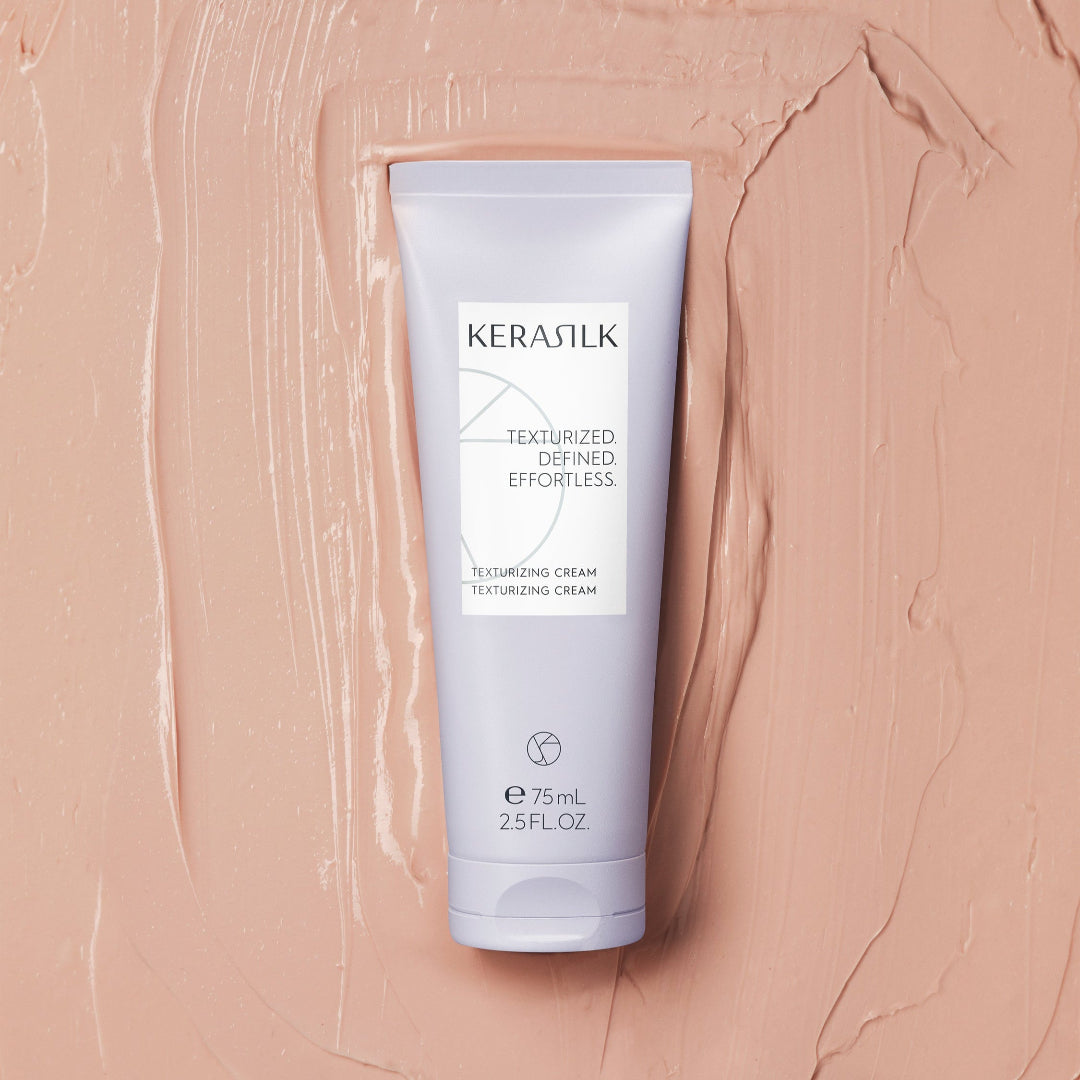 Kerasilk hair product tube on a beige textured background