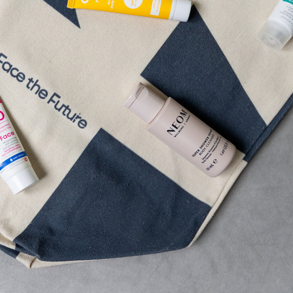 Cosmetic products on a 'Face the Future' branded bag