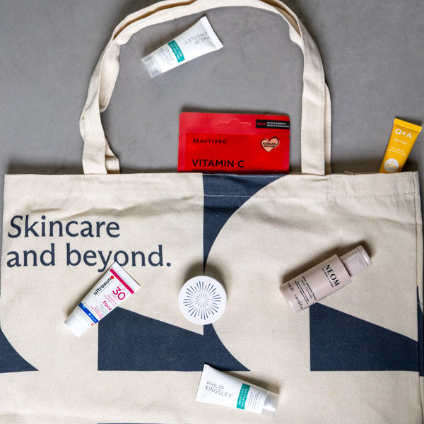 Tote bag with skincare products and 'Skincare and beyond' text on a gray background