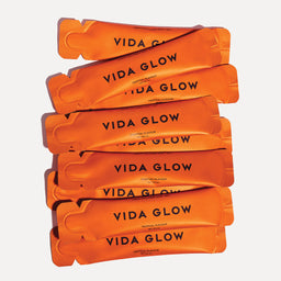 Stack of Vida Glow supplement bars on a white background