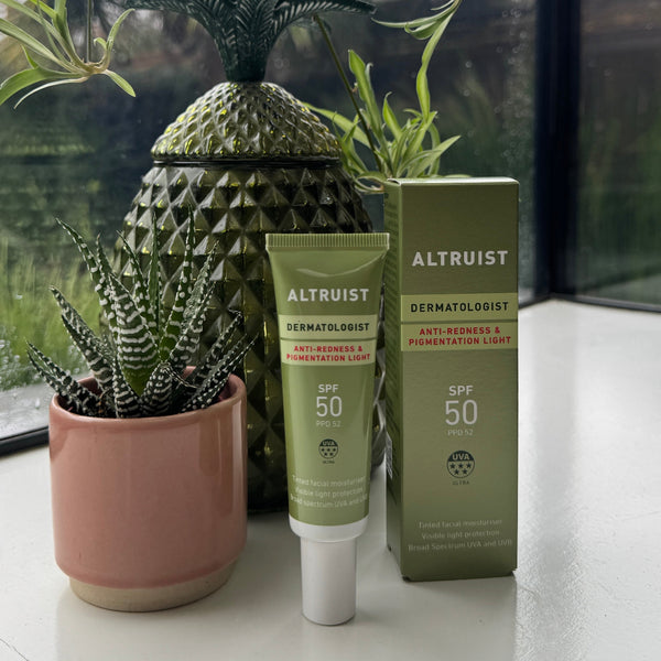 Altruist skincare product with a pineapple decoration and plants in the background