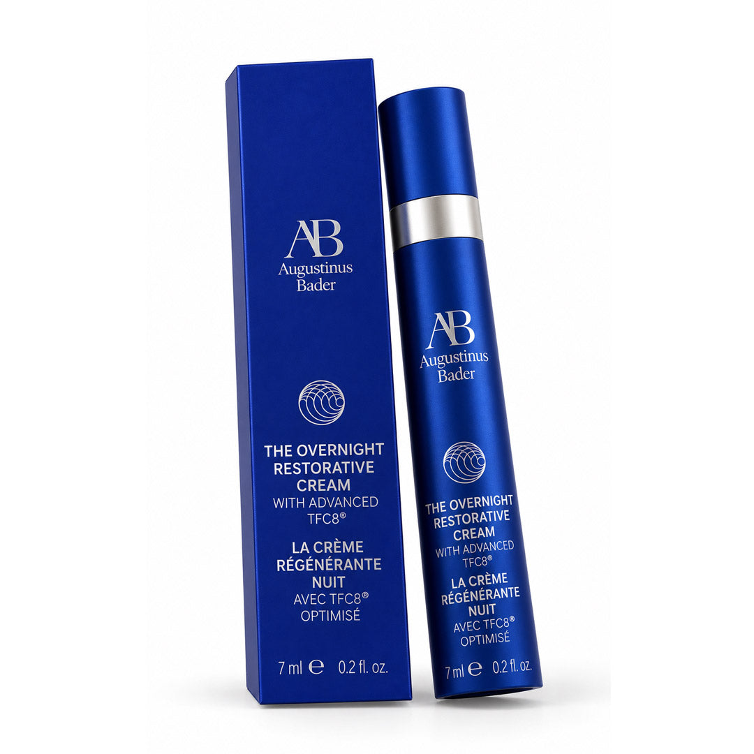 Augustinus Bader The Overnight Restorative Cream shown in a deep blue squeeze bottle next to its matching blue packaging box on a white background.