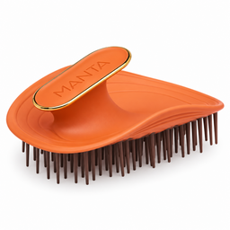 An orange Manta Detangling Hairbrush with dark brown bristles and a gold trim on the handle, shown on a clean white background.
