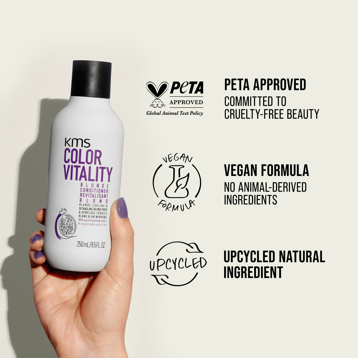 KMS Color Vitality shampoo bottle held by a hand with PETA approval and vegan formula labels on a light background.
