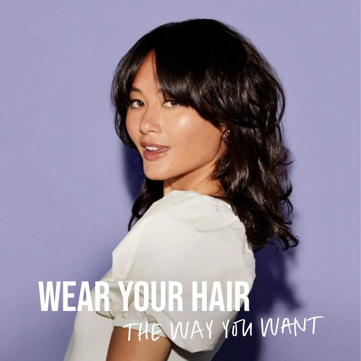 Woman with styled hair against a purple background with text 'Wear Your Hair The Way You Want'.