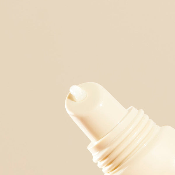 Close-up of a beige lip balm on a matching beige background