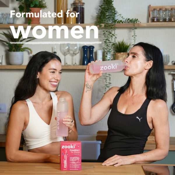 Two women sitting at a table with Zooki products in a casual setting.