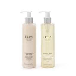 Two bottles of ESPA hand lotion on a white background