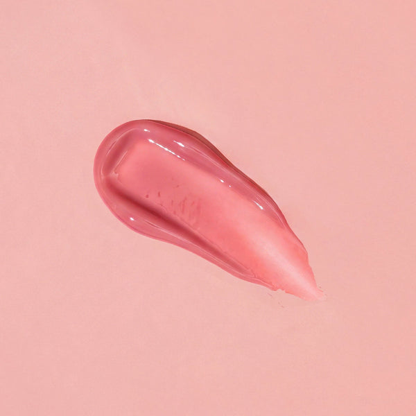 Pink lip balm smear on a pink background