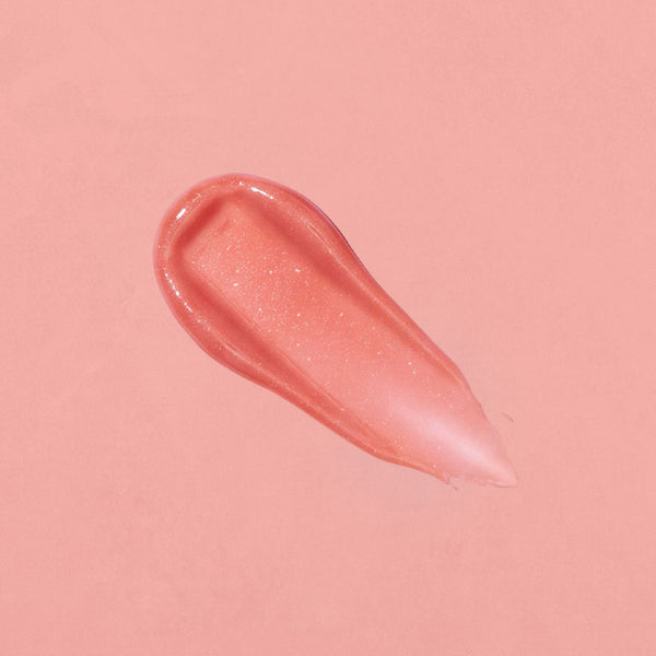 Pink lip gloss swatch on a pink background