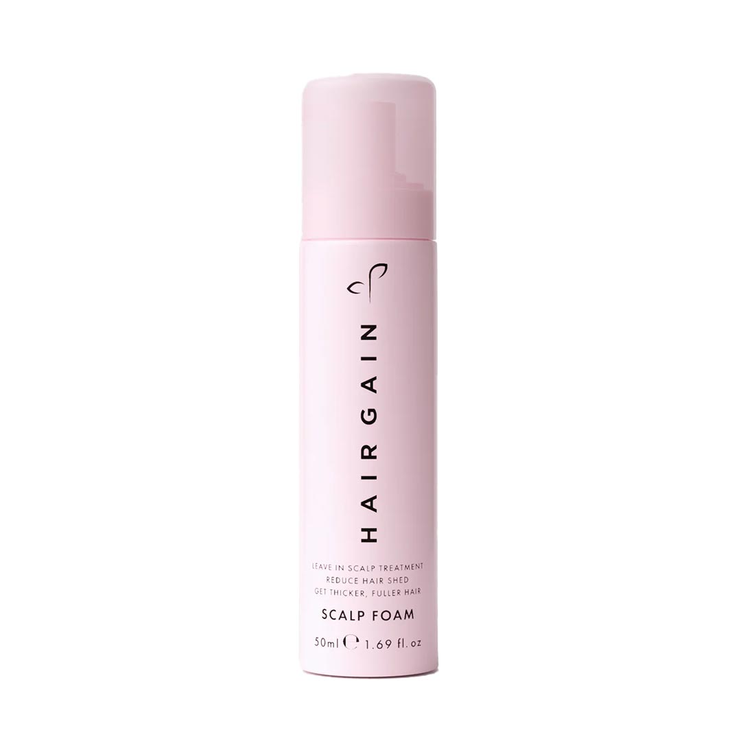 Pink bottle of HairGain scalp foam on a white background