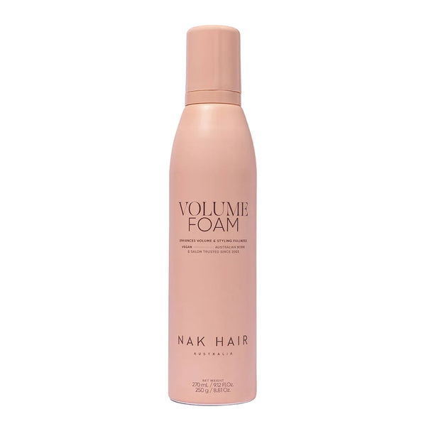 Pink bottle of NAK Hair Volume Foam on a white background