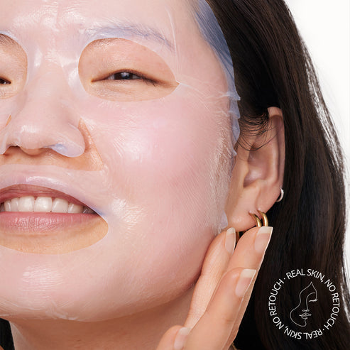 a model applying a mask to her face