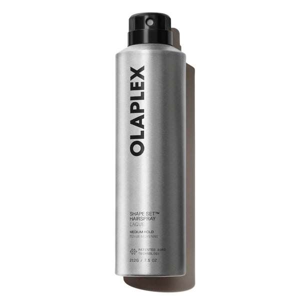 A silver aerosol can of Olaplex Shape Set Hair Spray with a black cap, shown on a clean white background with a soft shadow.