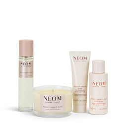 Neom skincare products including a candle, bottles, and a tube on a white background