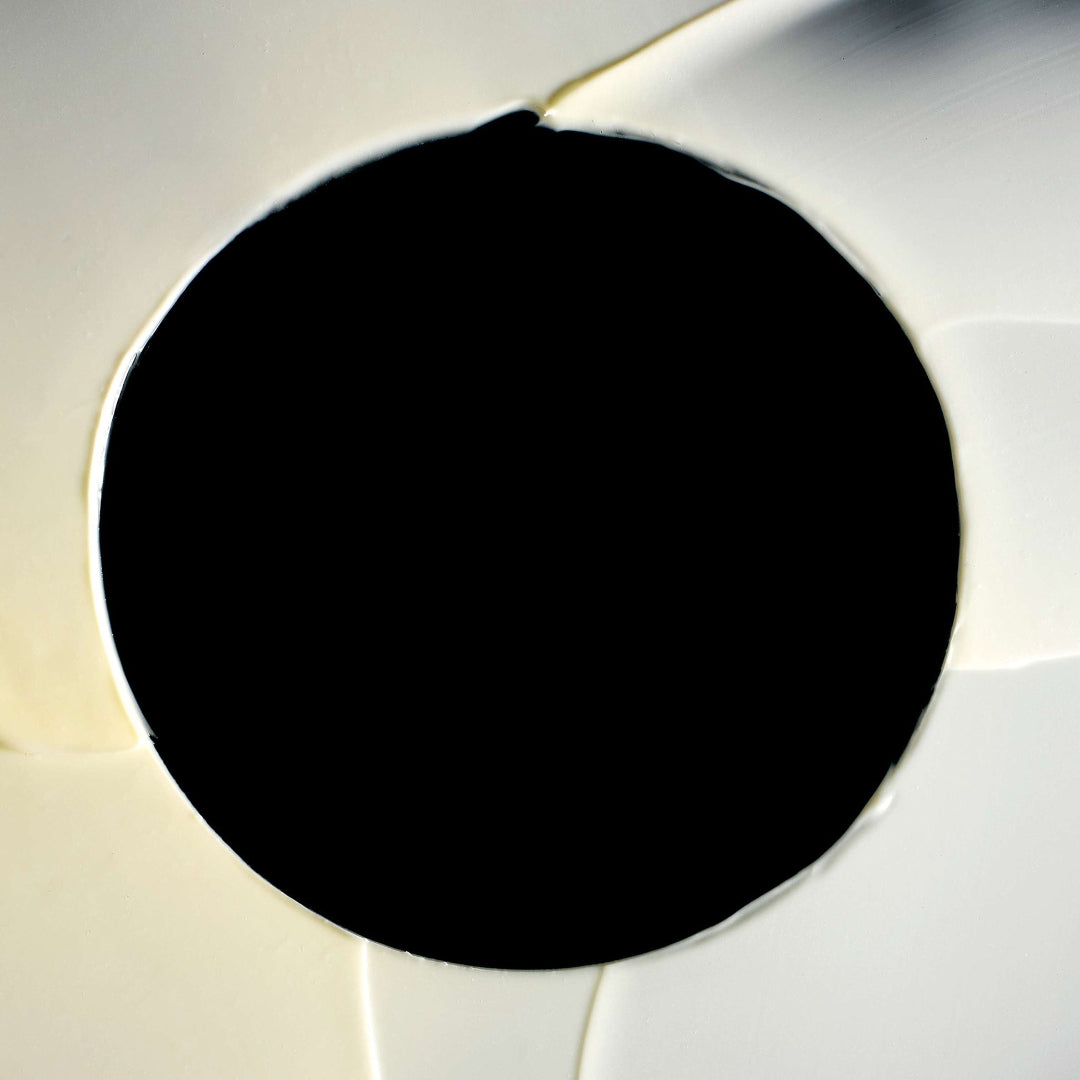 Close-up of a soccer ball with a black patch