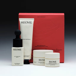 REOME skincare product set including bottles, jars, and a box on a gradient background