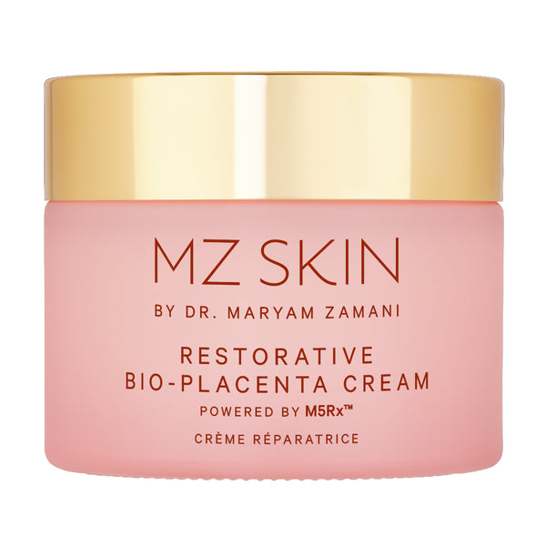 A pink cosmetic cream jar with a shiny gold lid, labeled 'MZ SKIN BY DR. MARYAM ZAMANI RESTORATIVE BIO-PLACENTA CREAM'.