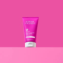 Super Facialist face scrub tube on a pink background