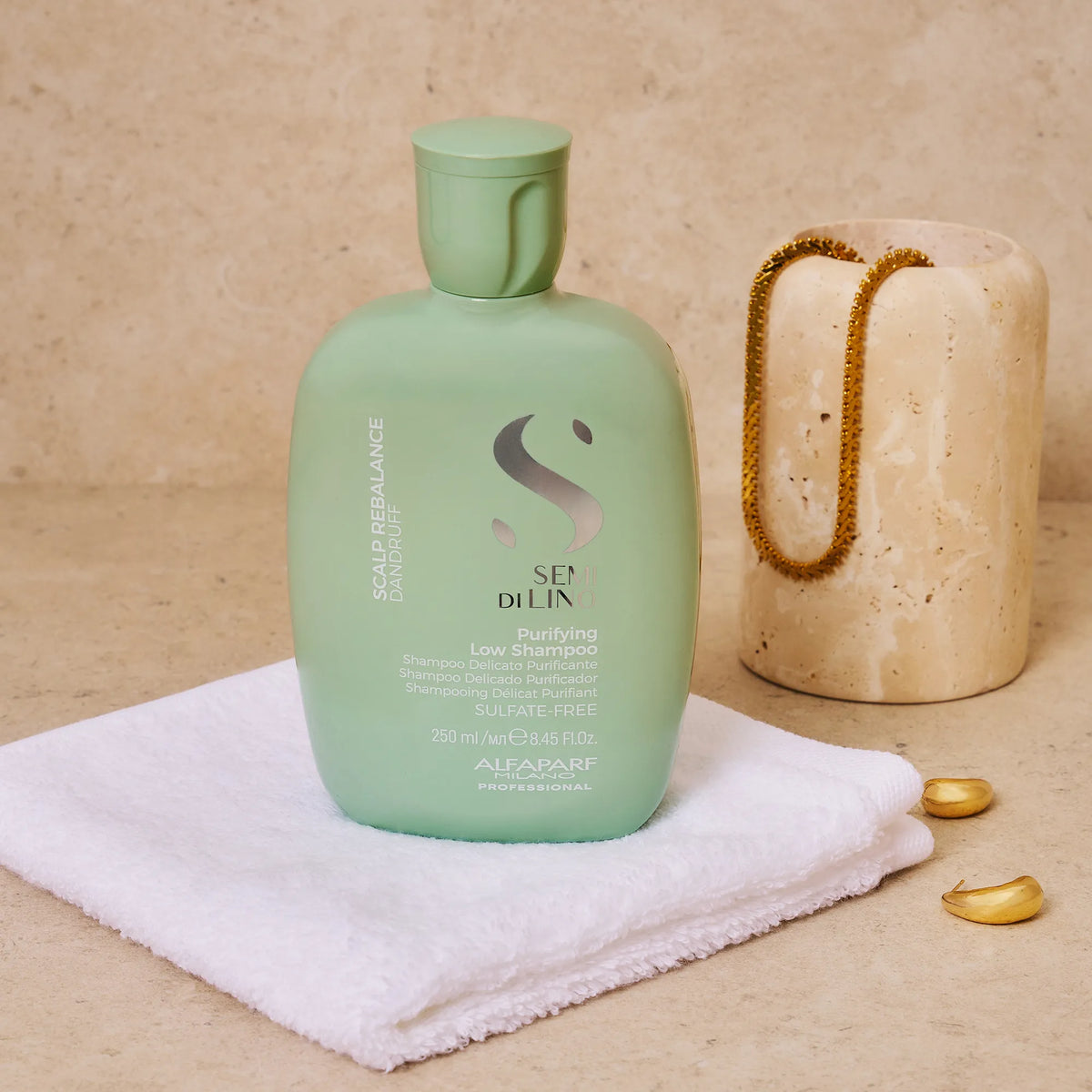 Green shampoo bottle on a towel with a beige background