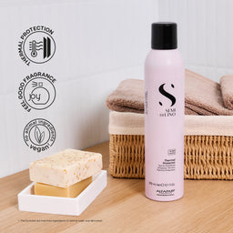 Stai di Lino hair product bottle with a sponge and towels on a wooden surface