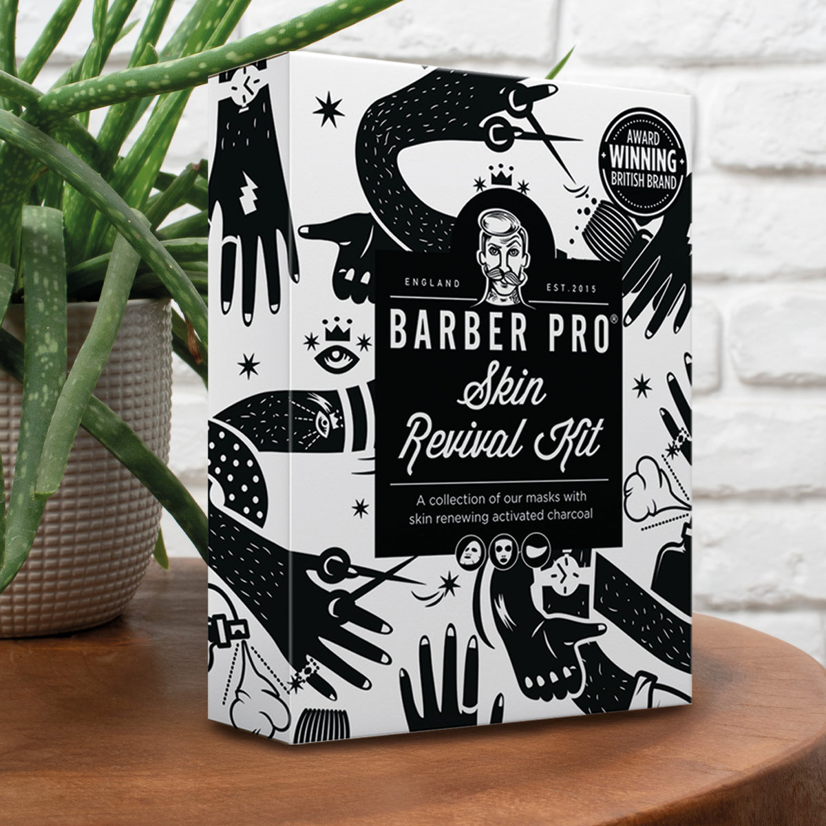 Barber Pro Skin Revival Kit packaging on a wooden surface with a plant in the background