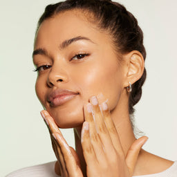 a model applying the wash to her face