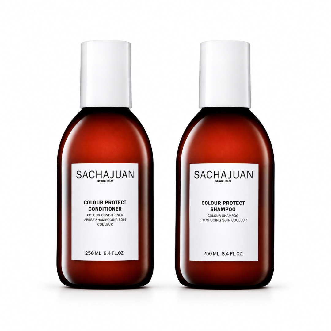 Two Sachajuan Stylenium Colour Protect haircare bottles on a white background, featuring an amber brown bottle with a white cap for the conditioner and a matching bottle for the shampoo.