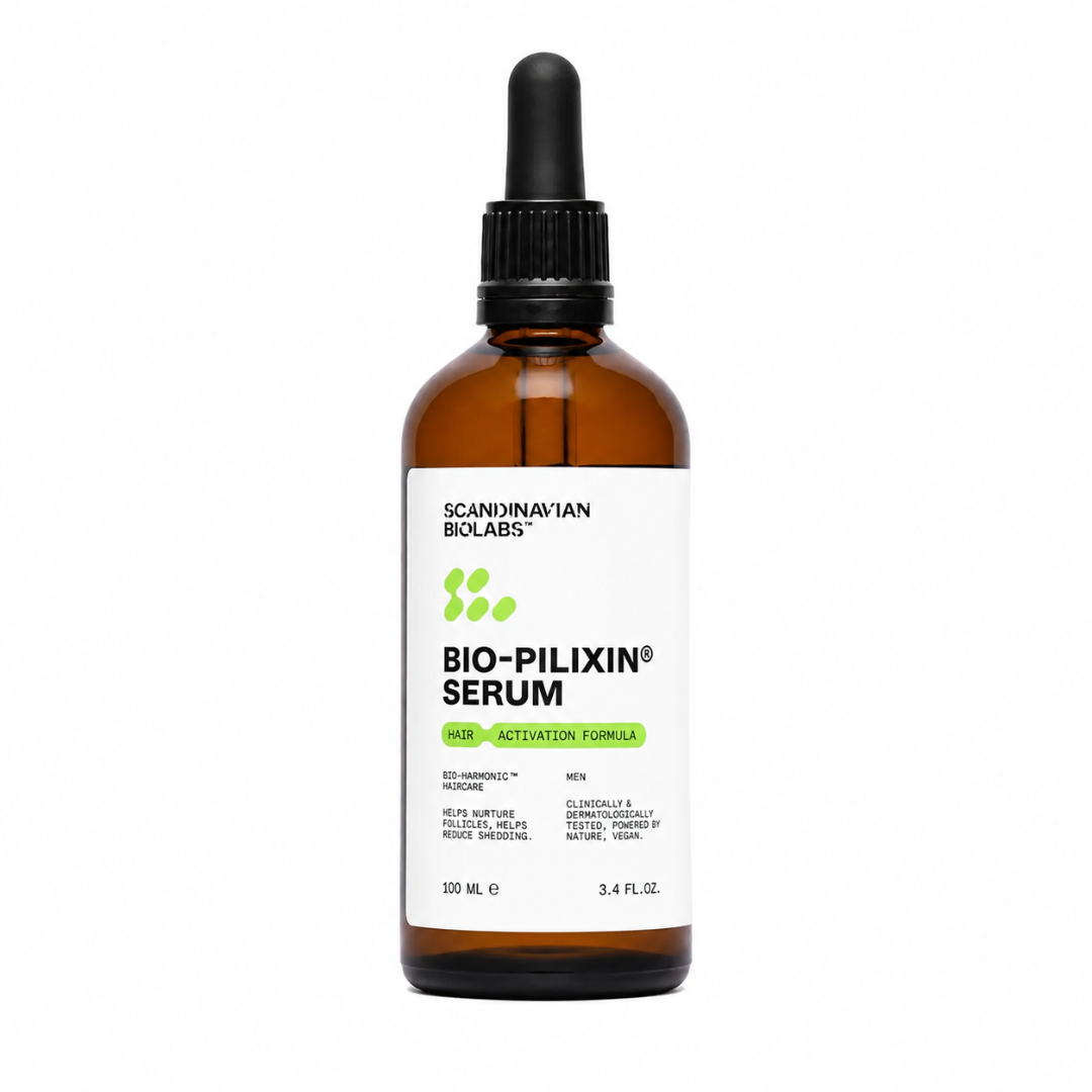 A 100 mL amber glass dropper bottle of Scandinavian Biologs Bio-Pilixin Serum for men, featuring a white label with green and black text, and a black dropper cap, set against a plain white background.