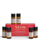 NEOM Wellbeing London Scent the Season Discovery Set, featuring a red gift box and six amber glass essential oil bottles with black caps and cream labels, arranged on a white background.