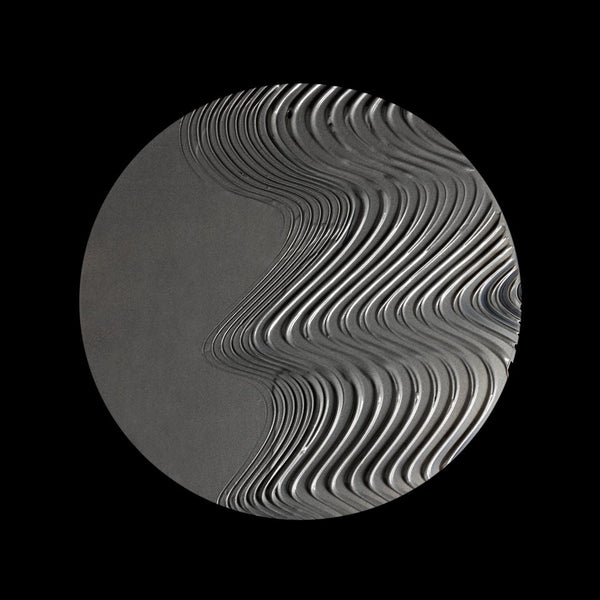 A circular gray object with a wavy, layered ribbed pattern on a solid black background.