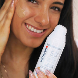 White Ultrasun Face Tinted Anti-Pigmentation SPF 50+ bottle being applied to face