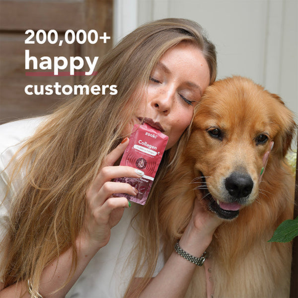 A woman and a golden retriever dog are shown together indoors, with the woman holding a pink pouch labeled 'Zoo' and 'Collagen'. Large white text in the upper left reads '200,000+ happy customers'.