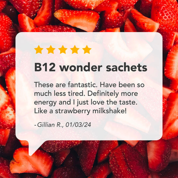 A promotional graphic with a white speech-bubble style card over a background of sliced red strawberries. The card reads 'B12 wonder sachets' with five yellow stars and a customer review quote by Gillian R.