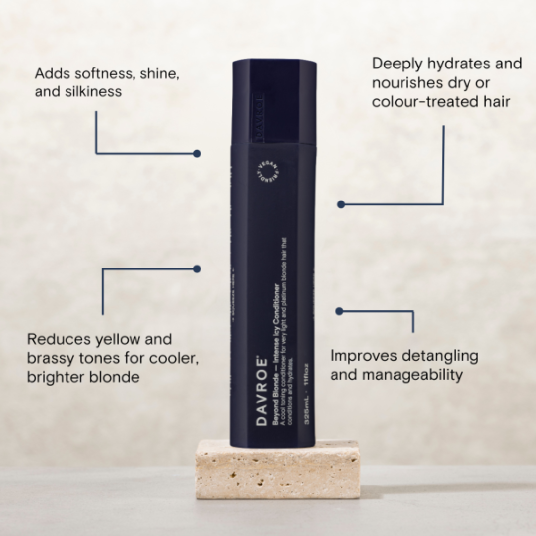 A single Davroe Personal Care Conditioner bottle stands upright on a small stone pedestal against a light textured background, surrounded by callout lines and text describing hair benefits.